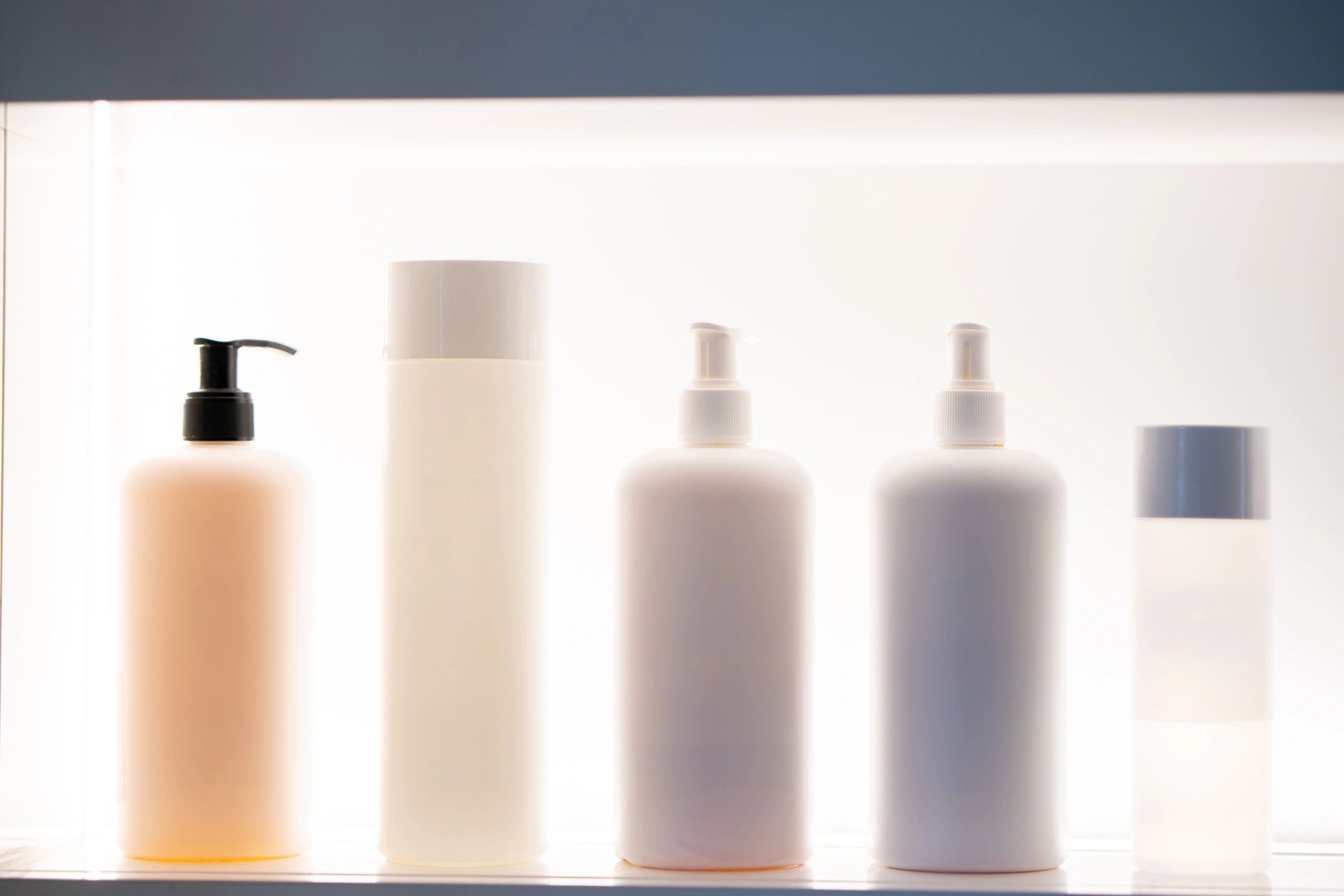 Hair and facial care products displayed on a salon shelf
