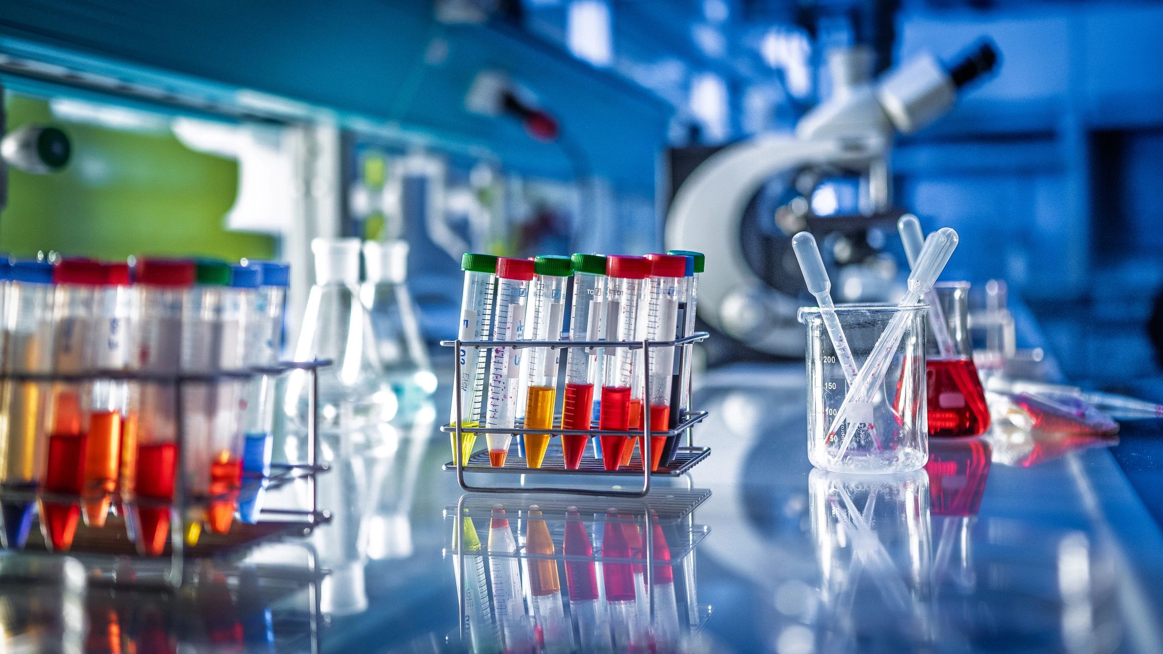 Laboratory bench with chemical samples, test tubes, and microscope
